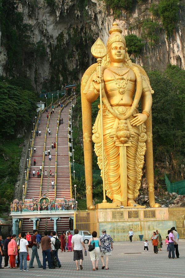 A gilded statue of Murugan beside the stairway to the Batu Caves