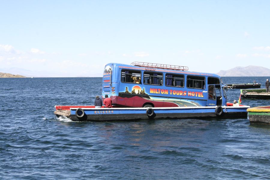 A painted passenger launch crossing open lake water